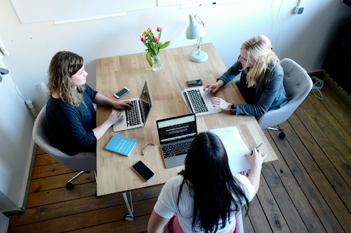 Small creative team brainstorming at a table with laptops. Source: Unsplash – small team Small creative team brainstorming at a table with laptops. Source: Unsplash – small team